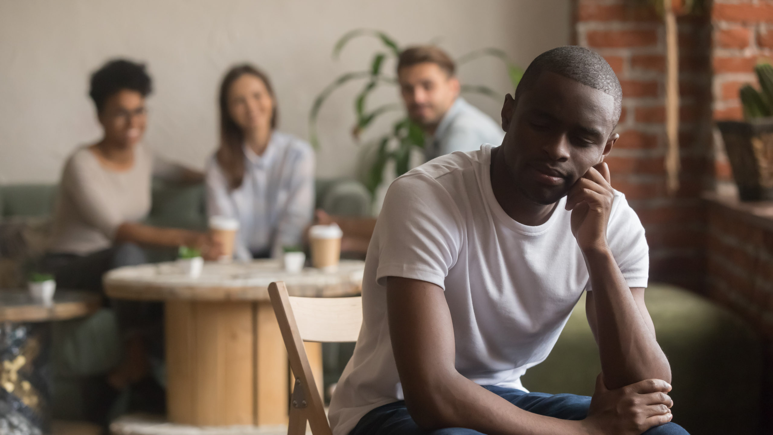 Upset lonely african american man suffering from bullying racial discrimination