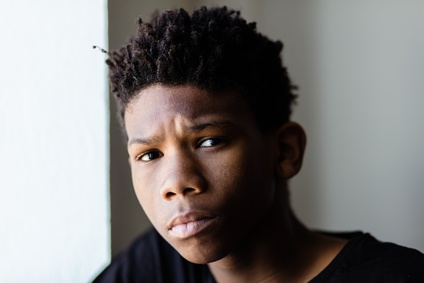 Concerned worried young African boy